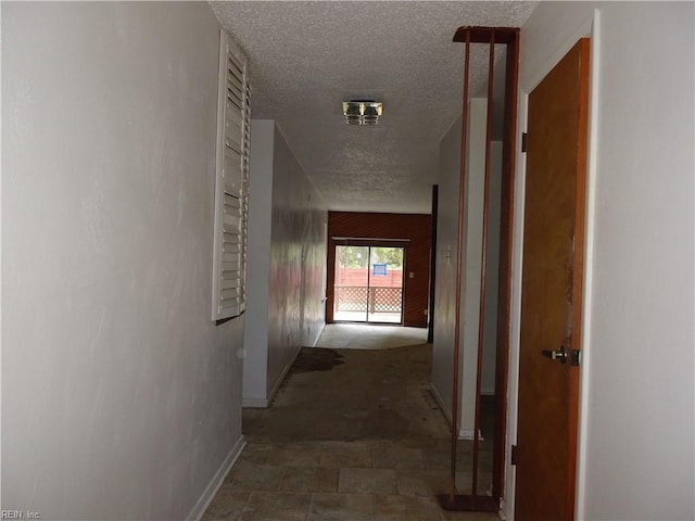 hall with a textured ceiling