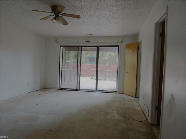 empty room featuring ceiling fan and a textured ceiling