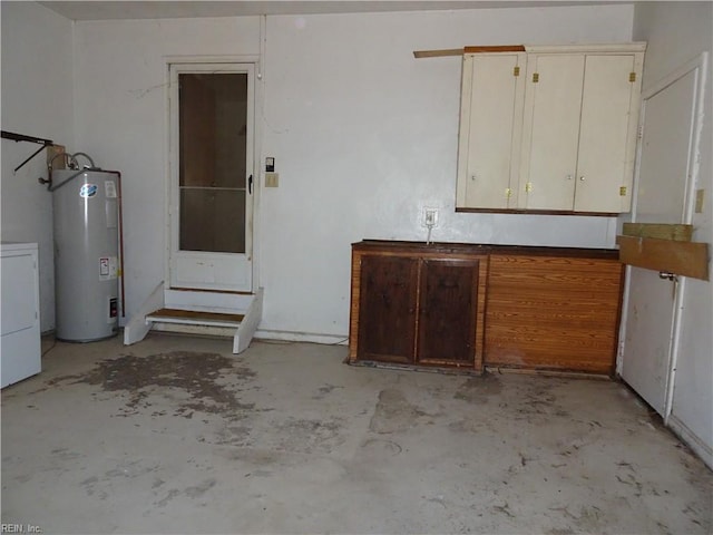 garage featuring water heater and washer / dryer