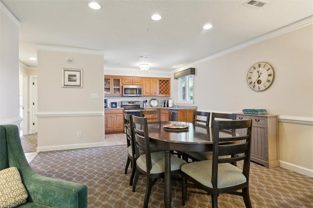 dining space featuring crown molding