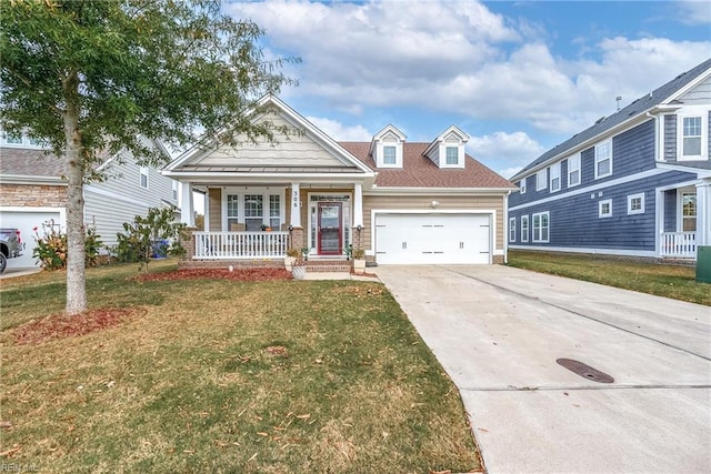 view of front of house featuring a porch, a garage, and a front lawn