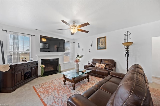 carpeted living room featuring ceiling fan