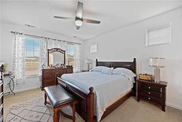 carpeted bedroom featuring ceiling fan and multiple windows