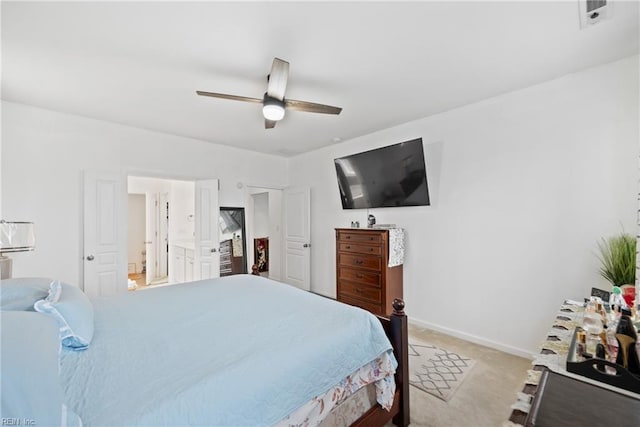 carpeted bedroom featuring connected bathroom and ceiling fan