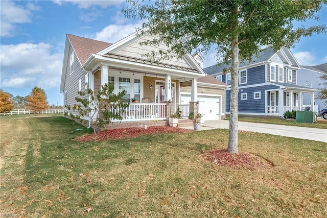 view of front of house with a garage, covered porch, and a front lawn