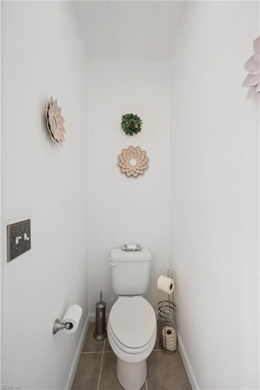 bathroom with toilet and tile patterned floors