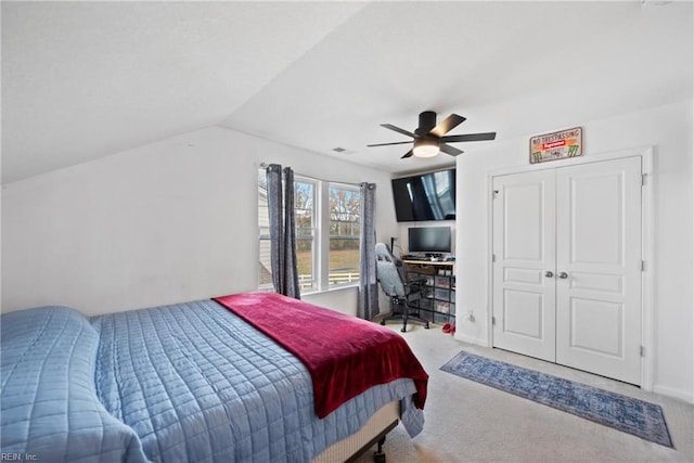 bedroom with ceiling fan, light colored carpet, and lofted ceiling