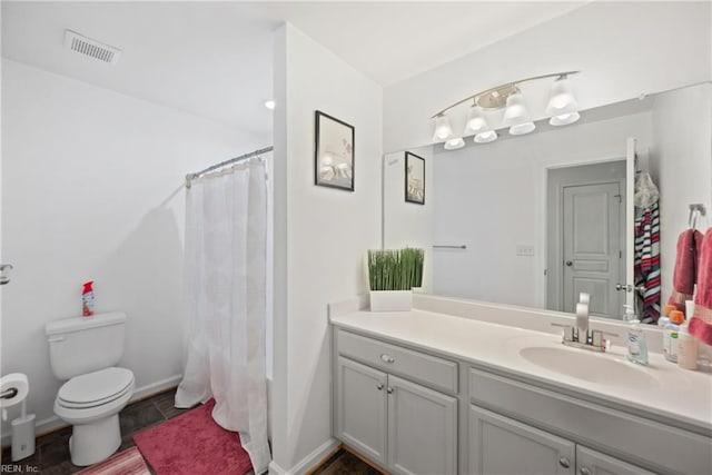 full bathroom featuring shower / bath combination with curtain, vanity, and toilet