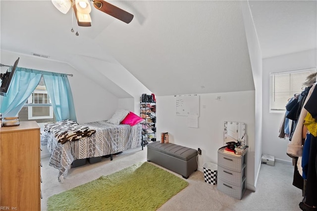 carpeted bedroom with multiple windows, lofted ceiling, and ceiling fan