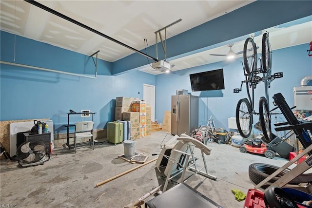 garage with stainless steel fridge and a garage door opener