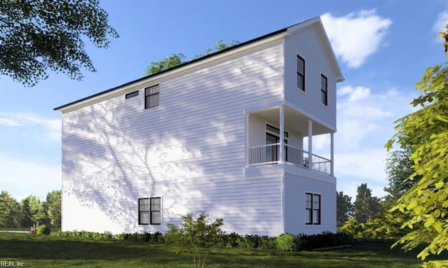 view of side of property with a yard and a balcony