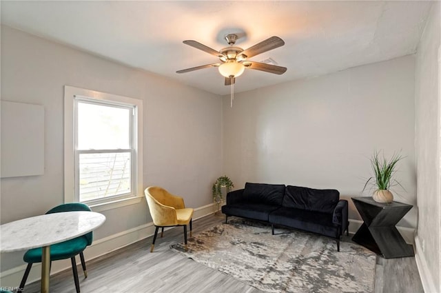 sitting room with ceiling fan and light hardwood / wood-style flooring