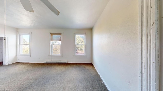 carpeted empty room featuring ceiling fan and baseboard heating