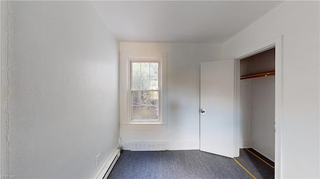 unfurnished bedroom with a closet and dark carpet