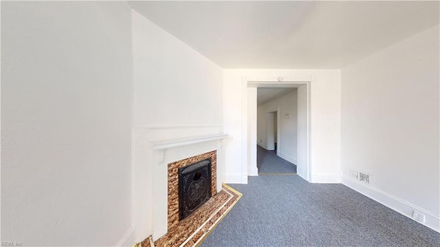 unfurnished living room featuring dark colored carpet