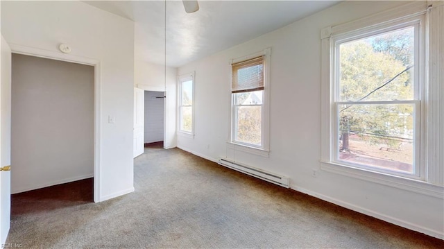 unfurnished bedroom with multiple windows, ceiling fan, a baseboard radiator, and carpet