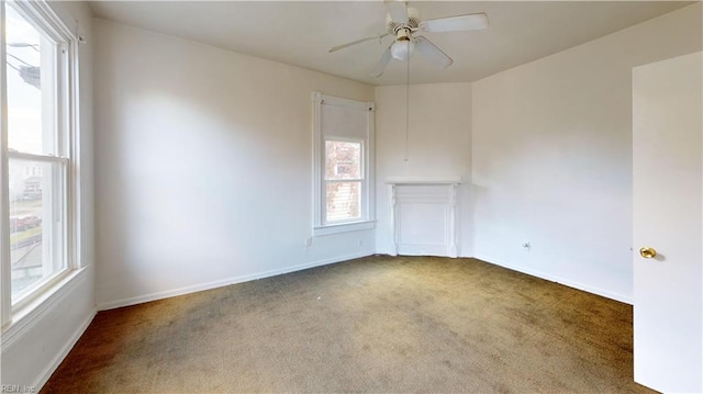 spare room featuring carpet and ceiling fan