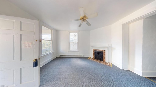 unfurnished living room with ceiling fan, dark colored carpet, and a baseboard heating unit