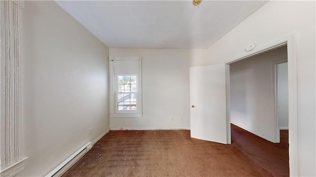 empty room featuring a baseboard radiator and dark carpet