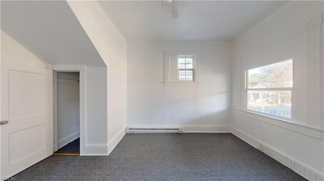 unfurnished bedroom with a closet, ceiling fan, dark carpet, and a baseboard radiator