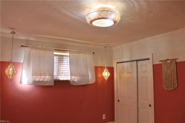 unfurnished bedroom featuring crown molding and a closet