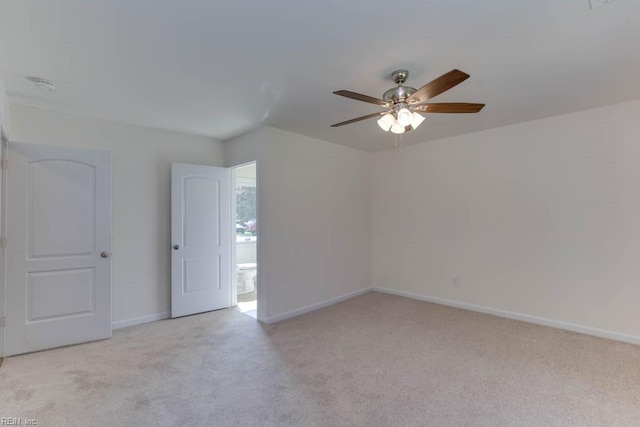 spare room featuring ceiling fan and light colored carpet