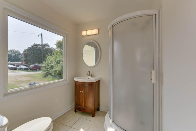 bathroom featuring walk in shower, tile patterned flooring, vanity, and toilet