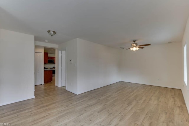 unfurnished room featuring ceiling fan and light hardwood / wood-style floors