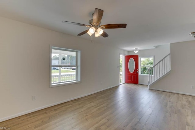 foyer with ceiling fan and light hardwood / wood-style floors