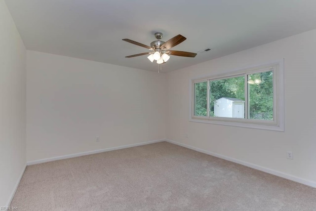 spare room with light carpet and ceiling fan