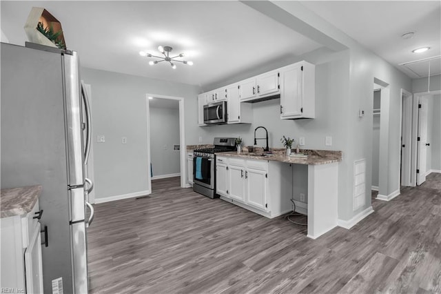 kitchen featuring stainless steel appliances, light hardwood / wood-style floors, white cabinetry, and sink