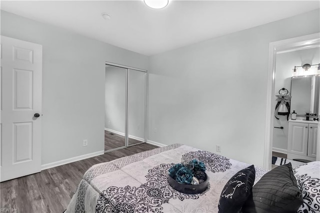 bedroom featuring connected bathroom, a closet, and dark hardwood / wood-style flooring