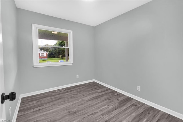 empty room with dark hardwood / wood-style floors