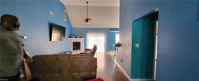 living room with high vaulted ceiling, hardwood / wood-style flooring, and ceiling fan