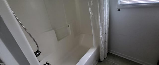 room details featuring shower / bath combo with shower curtain and tile patterned floors