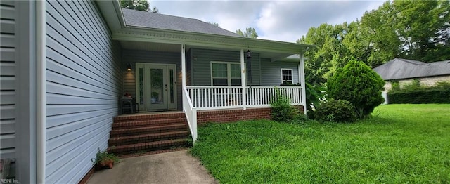 entrance to property with a lawn