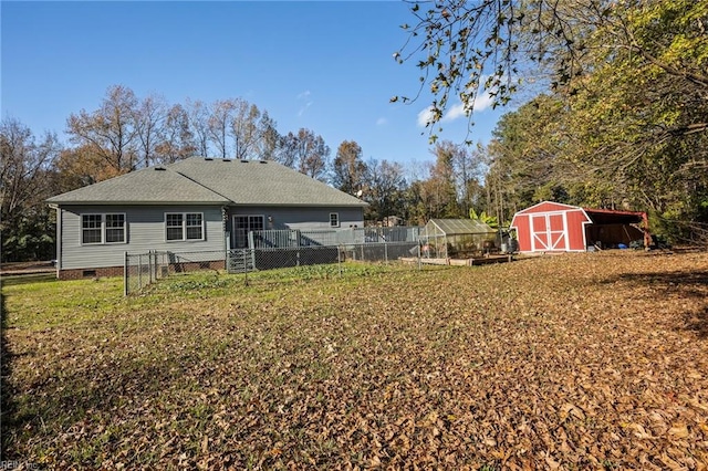 rear view of property with a carport and an outdoor structure