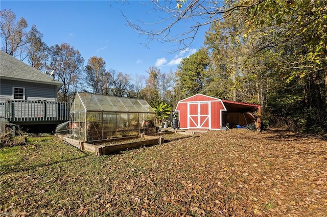 view of yard featuring an outdoor structure and a wooden deck