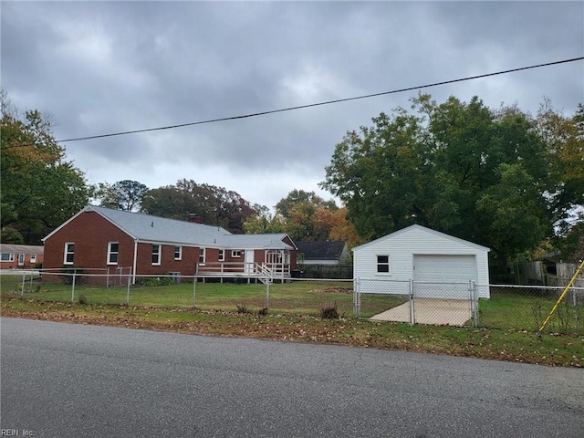 view of front of house with an outbuilding, a garage, and a front lawn