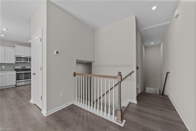 stairway with hardwood / wood-style flooring