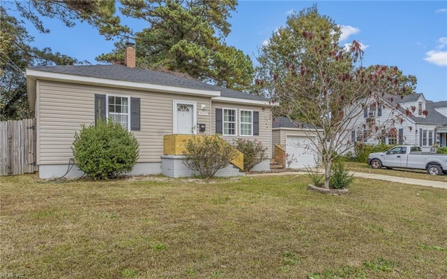 view of front of property featuring a garage and a front lawn