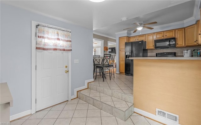 kitchen featuring light tile patterned flooring, ceiling fan, black appliances, and crown molding