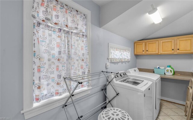 laundry room featuring light tile patterned floors, cabinets, and washer and dryer