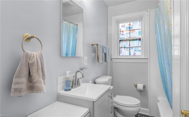 full bathroom featuring vanity, shower / bath combination with curtain, and toilet