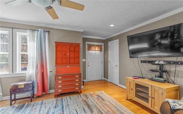 entrance foyer with ceiling fan, light wood-type flooring, and ornamental molding