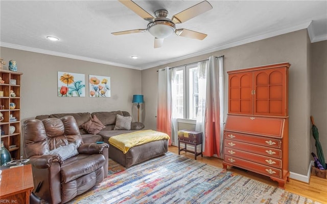 sitting room with light hardwood / wood-style floors, ceiling fan, and crown molding