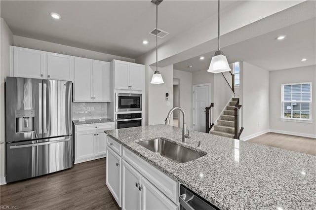 kitchen featuring sink, white cabinets, dark hardwood / wood-style floors, and appliances with stainless steel finishes