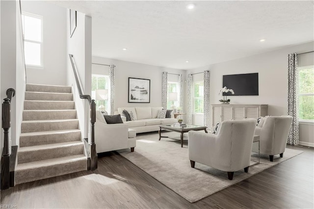 living room featuring wood-type flooring and plenty of natural light