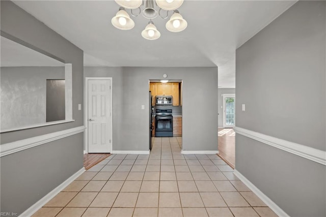 interior space featuring light tile patterned floors and an inviting chandelier