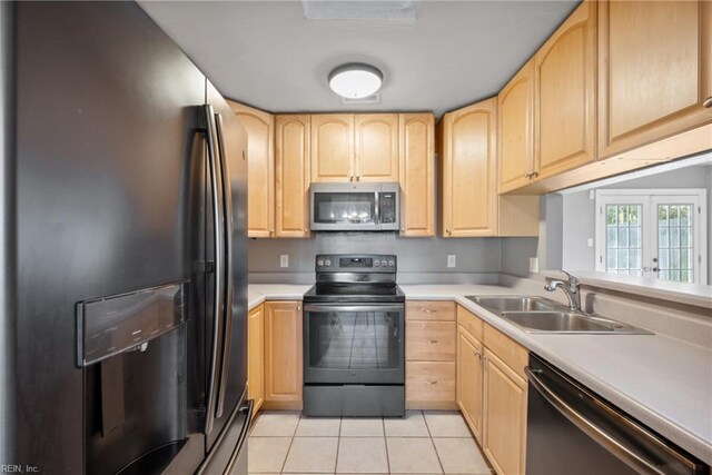 kitchen featuring stainless steel appliances, sink, light brown cabinetry, light tile patterned floors, and french doors